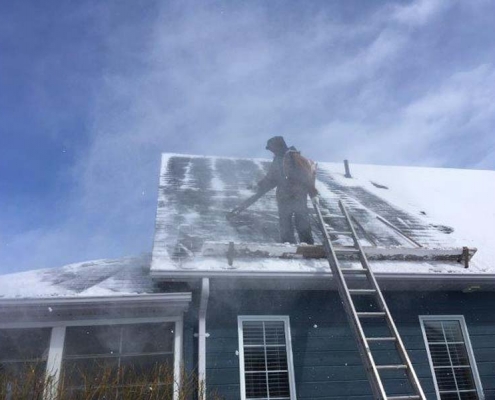 Winter Ice Damage leaf blower exposes shingles