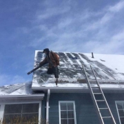 Winter Ice Damage leaf blower exposes shingles